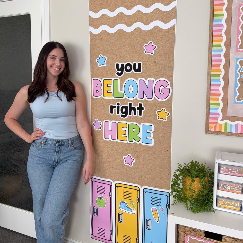 Kim from Learning with Kiki standing beside the Krafty Brights YOU BELONG RIGHT HERE printed classroom banner