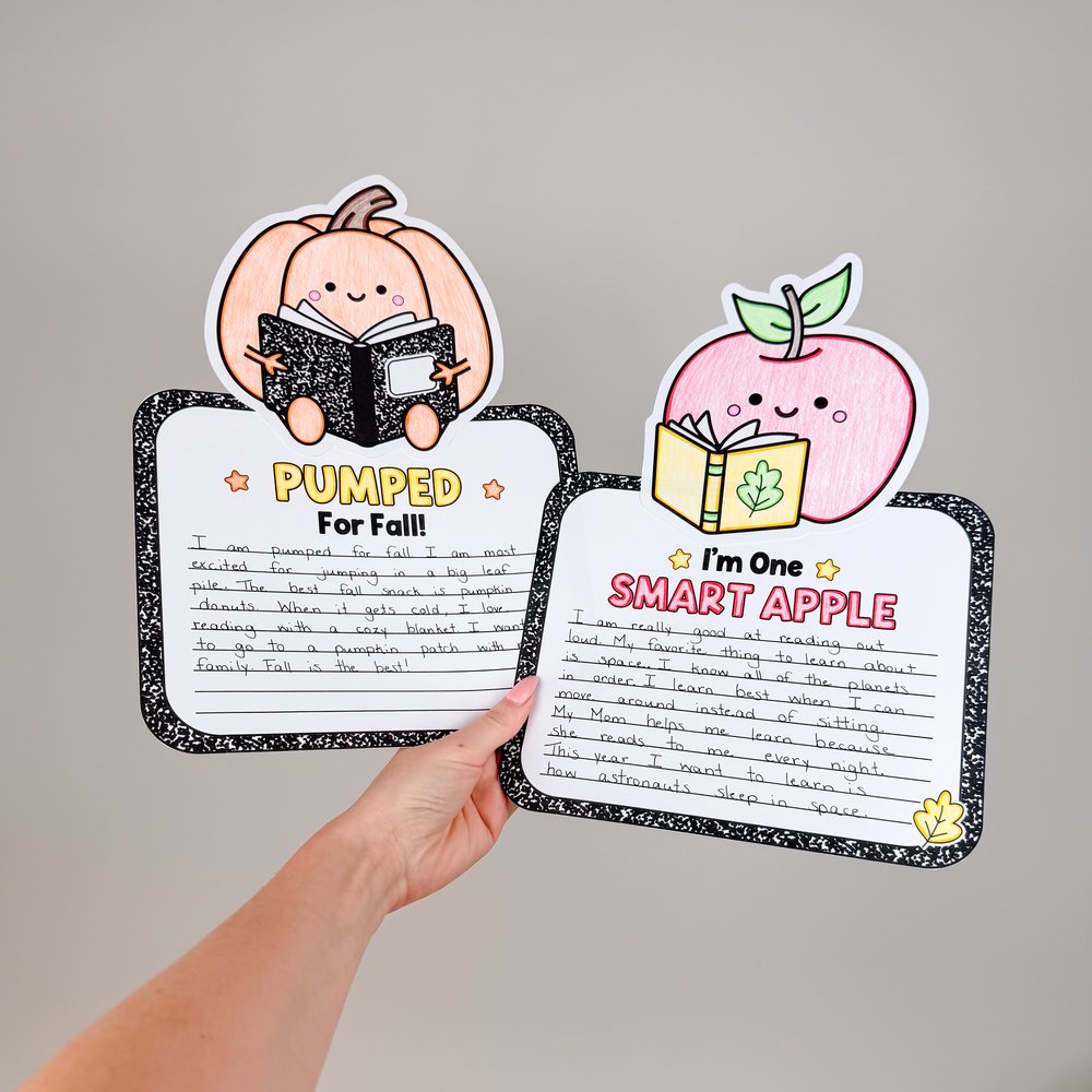Two completed fall writing crafts held up: Pumped for Fall with a colored pumpkin and I'm One Smart Apple with a colored apple, each with a student's handwriting