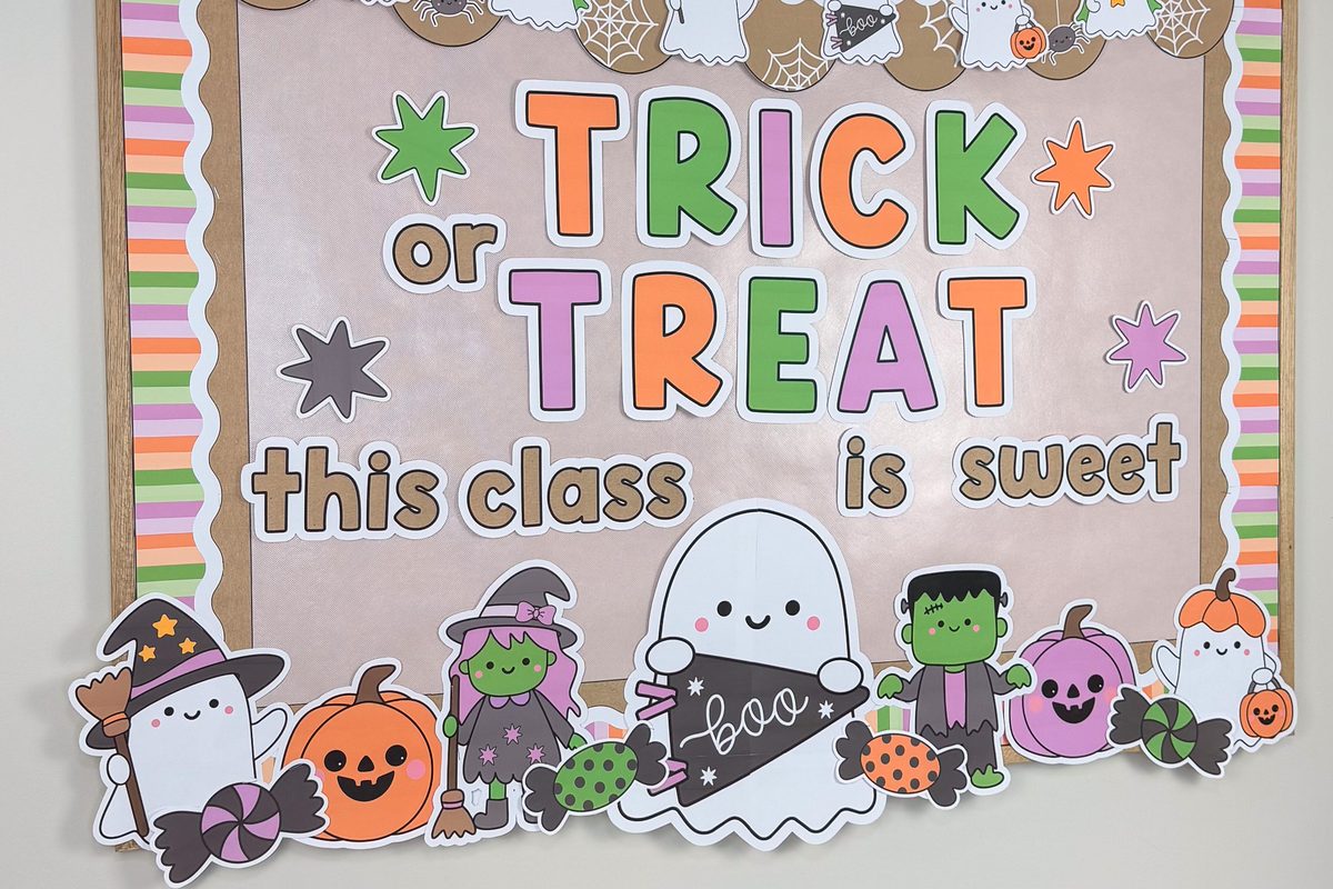 Halloween bulletin board cutouts along the bottom of the board: ghost with a boo pennant, witch, Frankenstein, jack-o'-lanterns, candy and a ghost in a witch hat