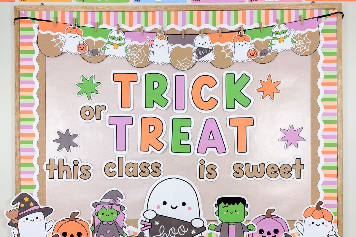 Close-up of the Halloween accent banner with little ghosts, spider webs and pumpkin pails above the TRICK OR TREAT letters on kraft paper